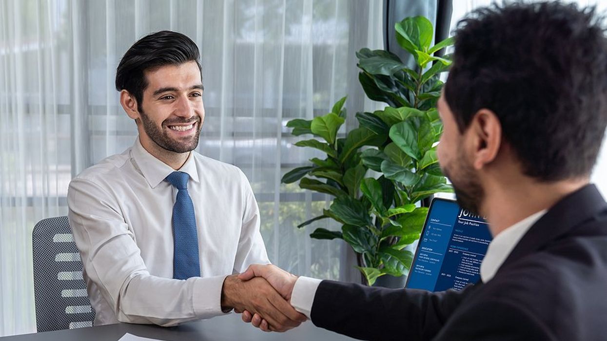 Recruiter interviewing candidate with a handshake